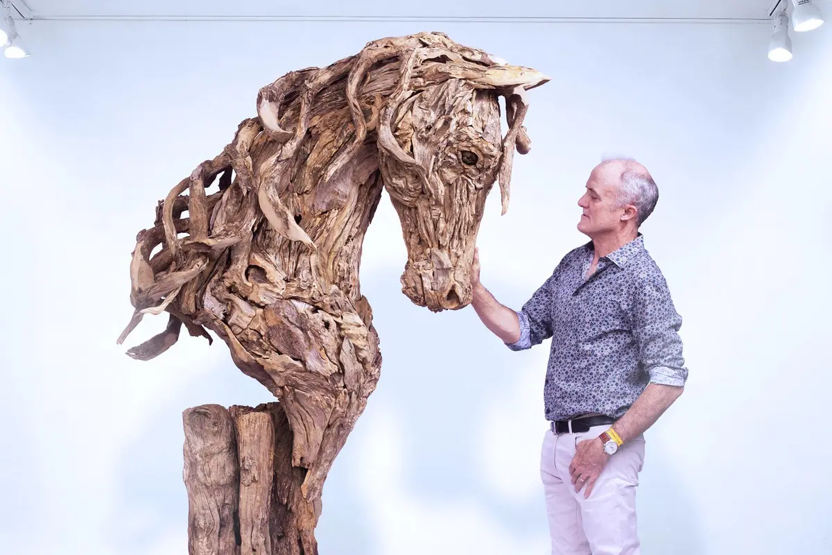 James Doran-Webb poses with a driftwood bust of a life-size horse. (Courtesy of James Doran-Webb)