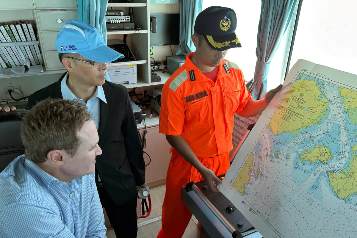 British Member of Parliament Tom Tugendhat looks at a map on board the Taiwan Coast Guard ship PP-10081 patrolling around Taiwan's Kinmen islands next to the Chinese coast, on July 9, 2026. (Ben Blanchard/Reuters)