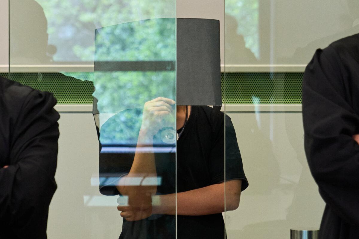 The defendant covering his face in the court during a trial against an online predator network of men accused of using chat groups to share tips on how to drug and rape women, in Berlin on July 8, 2026. (Ebrahim Noroozi/AP Photo)