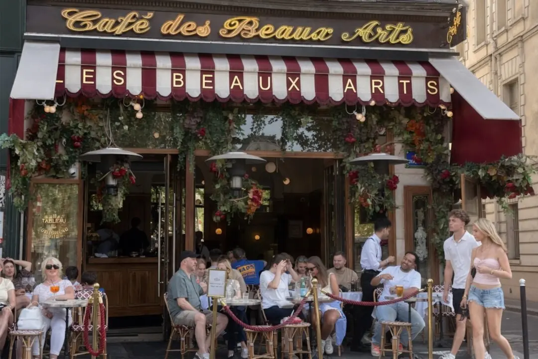 Parisians on the terrace of Café des Beaux Arts on July 5, 2026. During hot weather, many residents spend time at outdoor cafés. (Etienne Fauchaire/The Epoch Times)