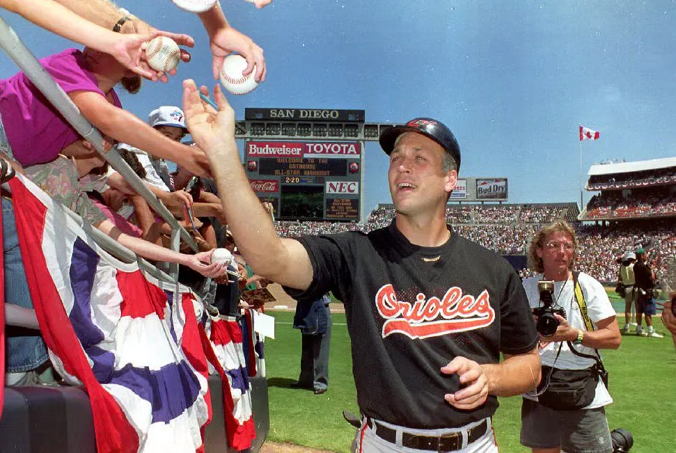 Cal Ripken Jr. of the Baltimore Orioles signs autographs on July 13, 1992, before the American League practice for the All-Star Game in San Diego. (Vince Bucci/AFP via Getty Images)