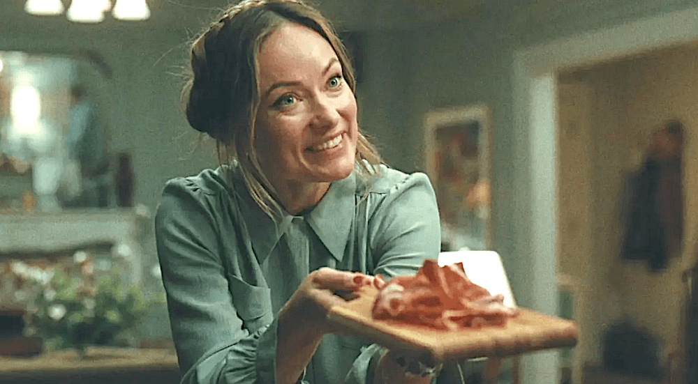 Angela (Olivia Wilde) offers charcuterie to dinner guests<span style="color: #ff0000;">,</span> in "The Invite." (Annapurna Pictures/A24)