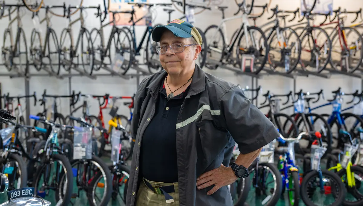 Diana Daniels in the bicycle shop where she works, a place she calls her Happy Place, in Springfield, Ohio, on July 3, 2026. (Glenn Hartong for The Epoch Times)