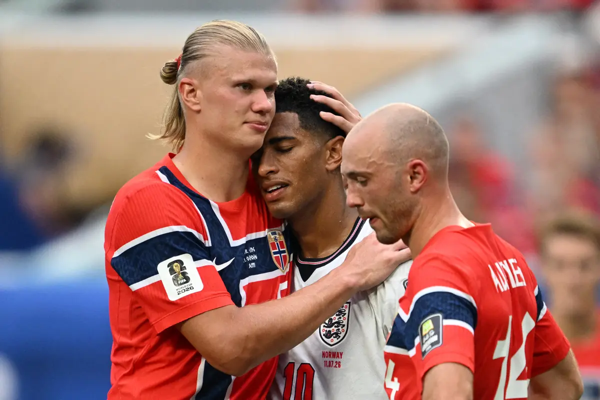 Norway striker Erling Haaland (L) congratulates England's midfielder Jude Bellingham (C) as Norway's midfielder Fredrik Aursnes looks on, after Bellingham scored his team's second goal during the 2026 World Cup football tournament quarterfinal match between Norway and England at Miami Stadium in Miami on July 11, 2026. (Roberto Schmidt / AFP via Getty Images)