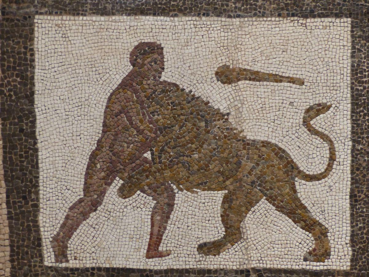 Heracles wrestling the Nemean lion. He uses a club to help subdue the lion. Detail of a Roman mosaic from Llíria (Valencia, Spain), A.D. 3rd century. Now in the Museo Arqueológico Nacional. (<a href="https://commons.wikimedia.org/wiki/User:Benjam%C3%ADn_N%C3%BA%C3%B1ez_Gonz%C3%A1lez">Benjamín Núñez González</a>/<a href="https://creativecommons.org/licenses/by-sa/4.0/">CC BY-S.A. 4.0</a>)