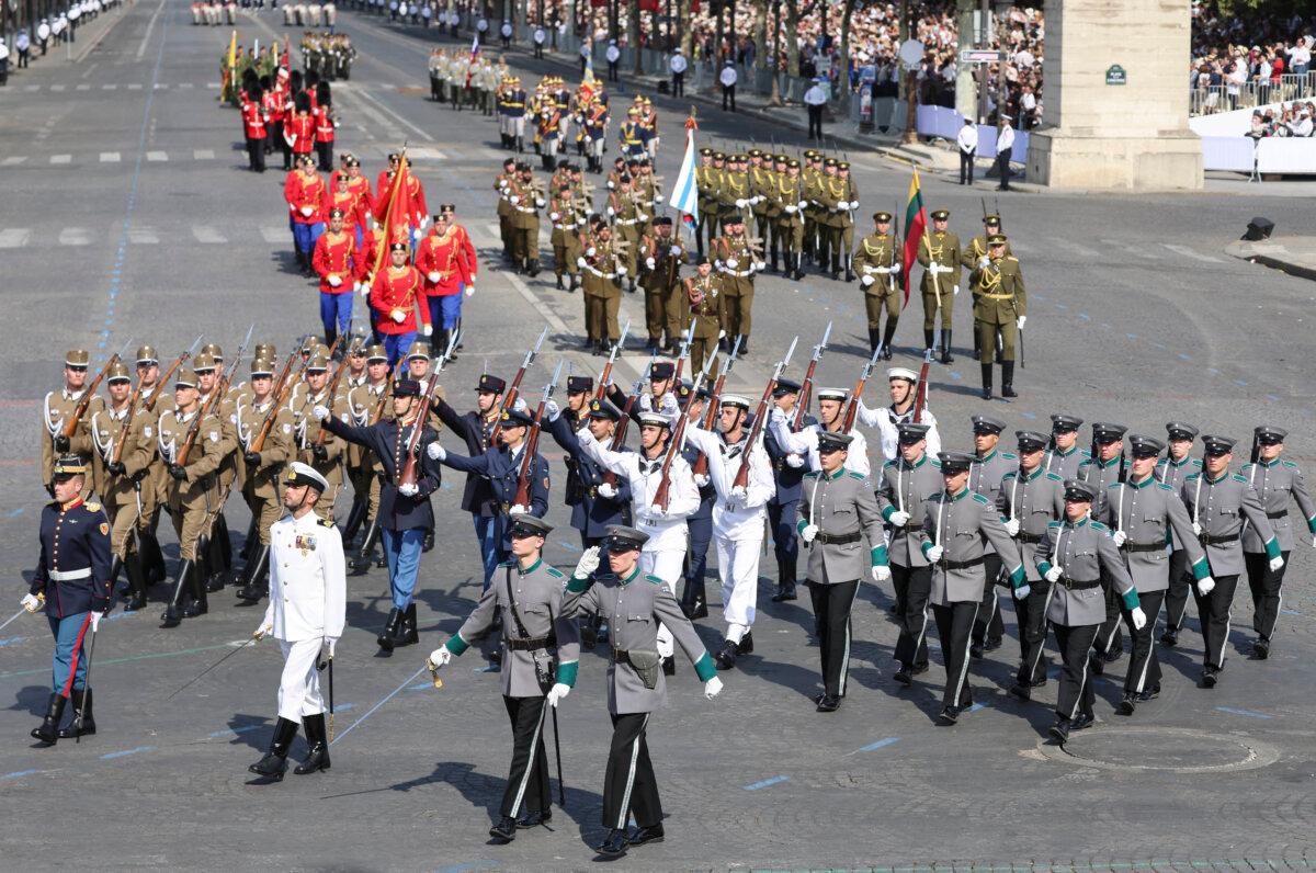 (From L) Members of the Coalition of the Willing from Hungary, Greece, and Finland march during the annual Bastille Day military parade on the Champs-Élysées Avenue in Paris, on July 14, 2026. (Ludovic Marin / AFP via Getty Images)