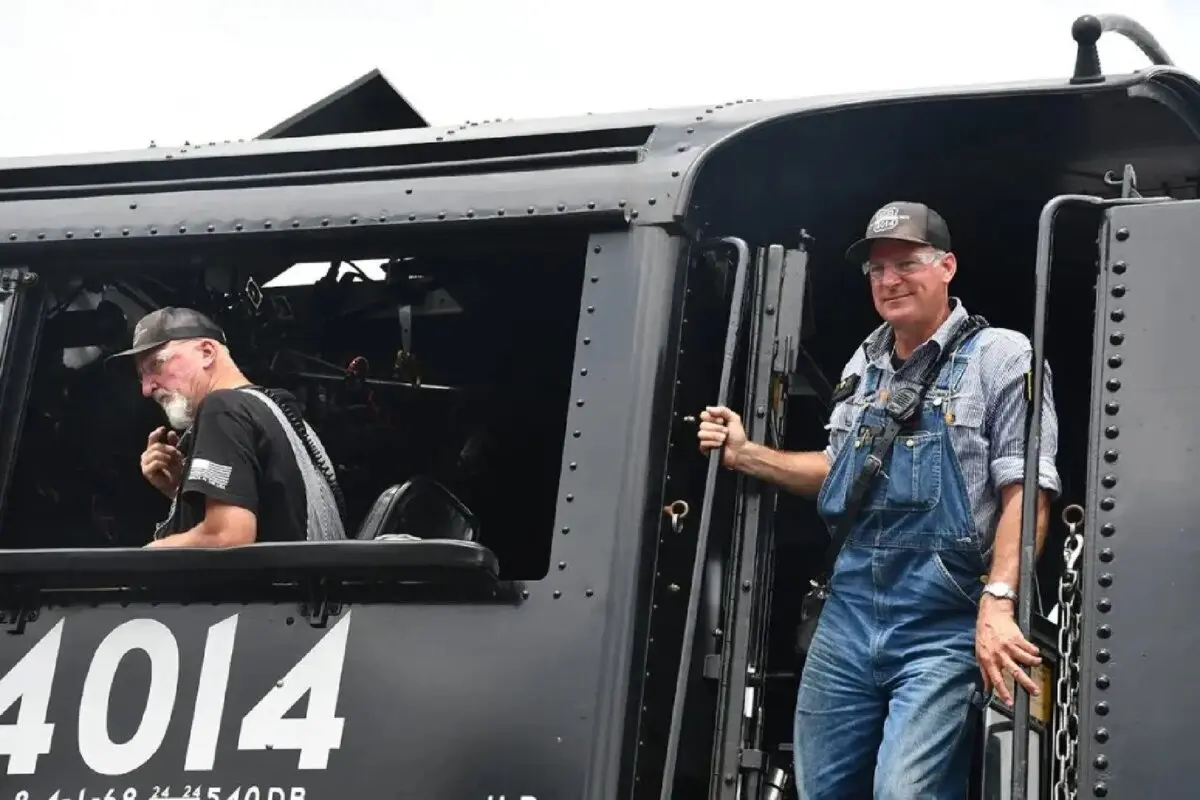 The crew of the Union Pacific “Big Boy” No. 4014 locomotive, including Ed Dickens (R), engineer and Union Pacific Railroad’s senior manager of heritage operations, and Ted Scheften (L), conductor, engineer, and fireman, at the railyard in Blair County, Pennsylvania. (Courtesy of Shannon Venditti)