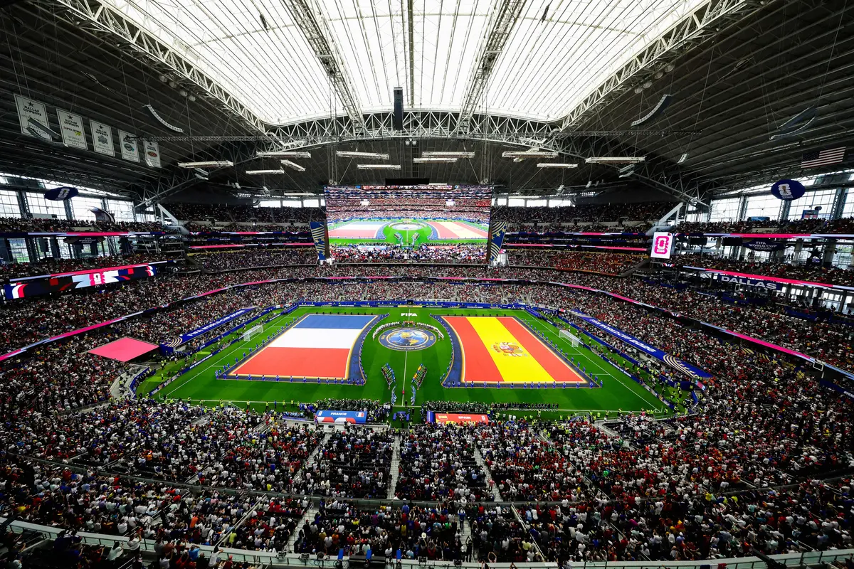 Frances' players (L) and Spain's players (R) stand for the national anthems ahead of the 2026 World Cup football tournament semifinal match at the Dallas Stadium in Arlington on July 14, 2026. (Aric Becker / AFP via Getty Images)