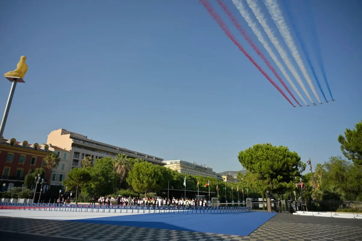 France's Air Force Elite aerobatic flying team "Patrouille de France" releases trails of France's national colors as they perform a flyover during a ceremony marking the 10th anniversary of an attack that killed 86 people and injured more than 400 in Nice, on the French riviera city of Nice on July 14, 2026. (Philippe Magoni/POOL/AFP via Getty Images)
