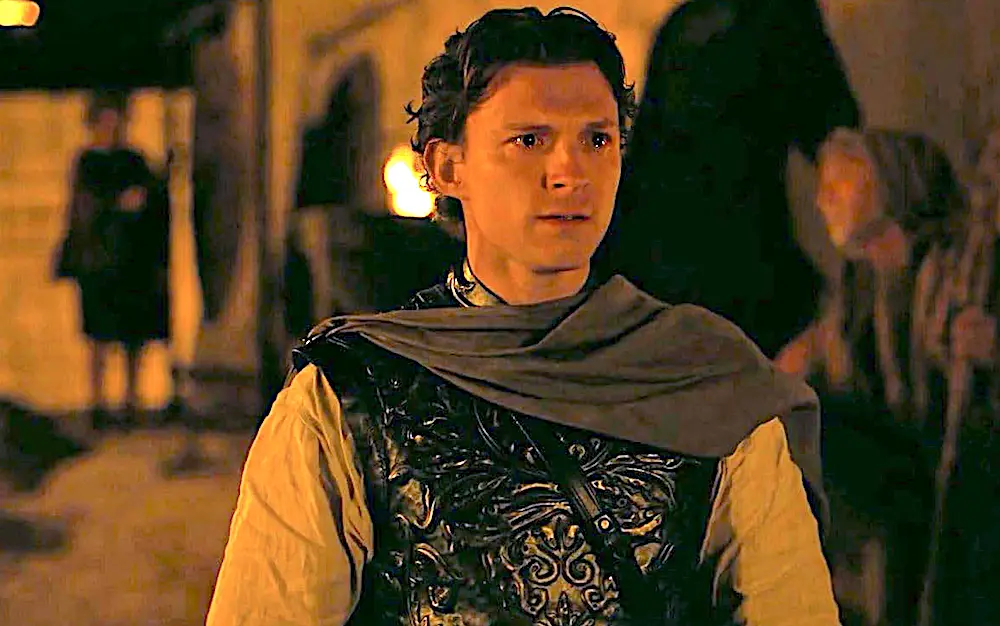 Telemachus (Tom Holland) faces a hall full of his mother's hostile suitors, who are angling for the throne of the long-gone Odysseus, in "The Odyssey." (Universal Pictures)