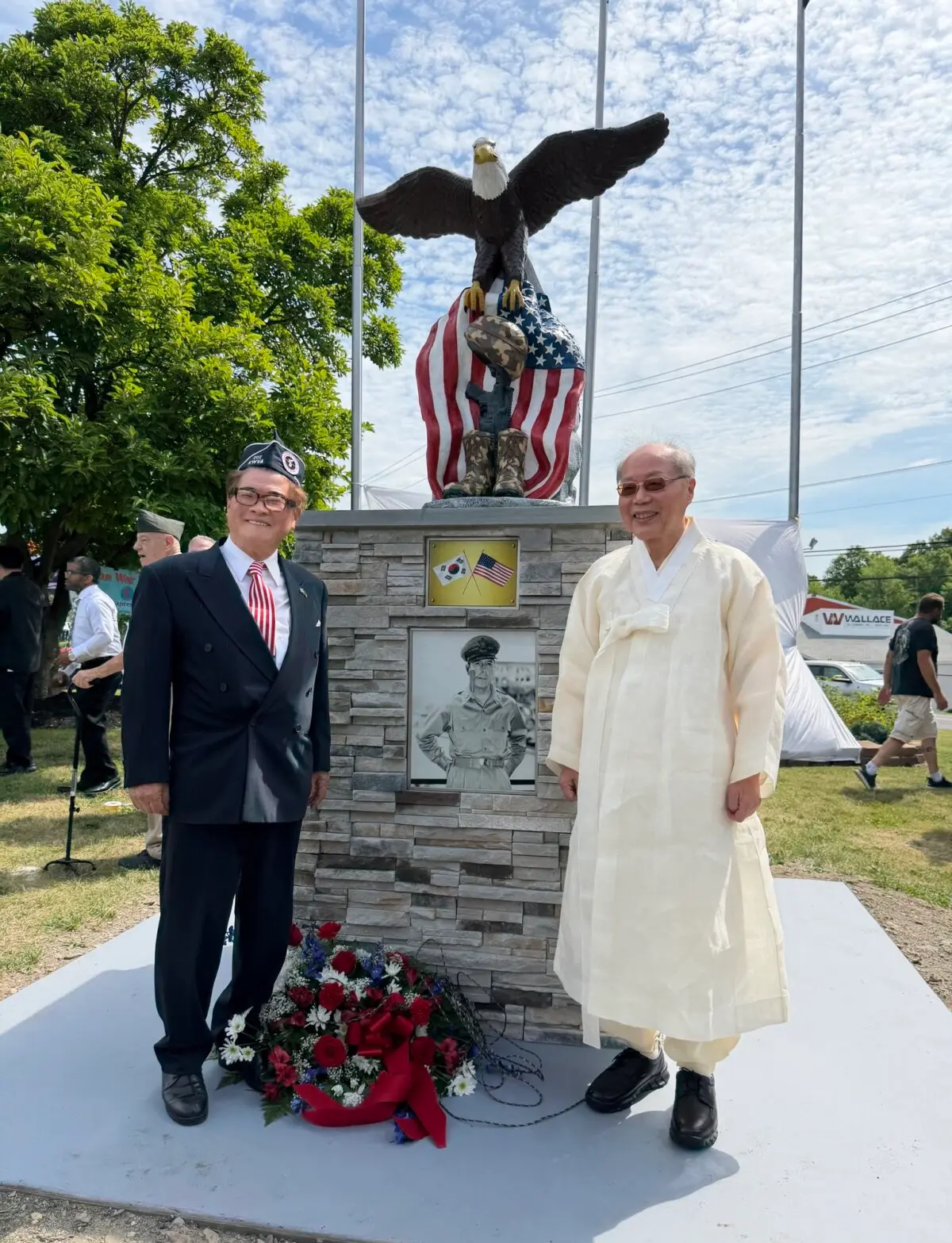 Dr. Hubert Ho-jae Lee, president of the Korean-American Foundation (L), and Dr. Seo Hyoseok shake hands in front of the newly unveiled Korean War memorial during the dedication ceremony in Walkill, N.Y., on June 25, 2026. (NTD)