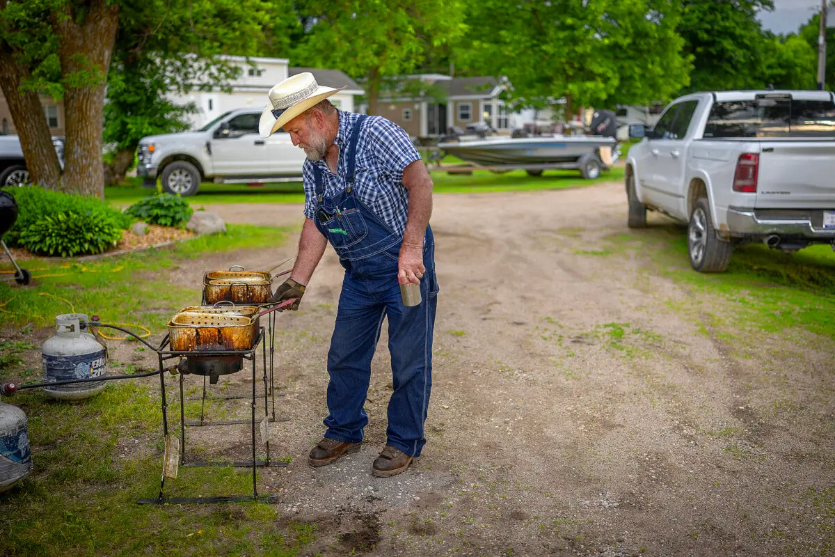 Chris VanHorn fries up the day’s catch at the 10-Mile Lake Resort in Dalton, MN on Thursday, June 4, 2026. The resort is moving into the 5th generation in one family this year, 120 years in the same family, longer than any resort in Minnesota. (Elizabeth Flores/The Minnesota Star Tribune/TNS)