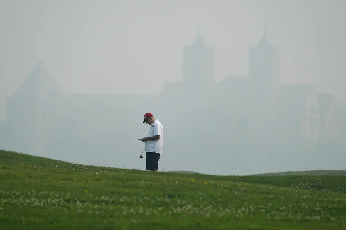 A golfer checks his score card at Willow Hills Golf course amid poor air quality due to dense smoke from Canadian wildfires in Northbrook, Ill., on July 16, 2026. (Nam Y. Huh/AP Photo)