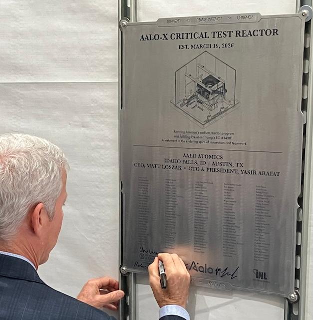 Secretary of Energy Chris Wright on June 25, 2026, signs a plaque commemorating Aalo Atomics’ Aalo-X test reactor’s installation at Idaho National Laboratory, less than 10 days before it became the fourth new reactor design to achieve criticality in less than a month. (John Haughey/The Epoch Times)