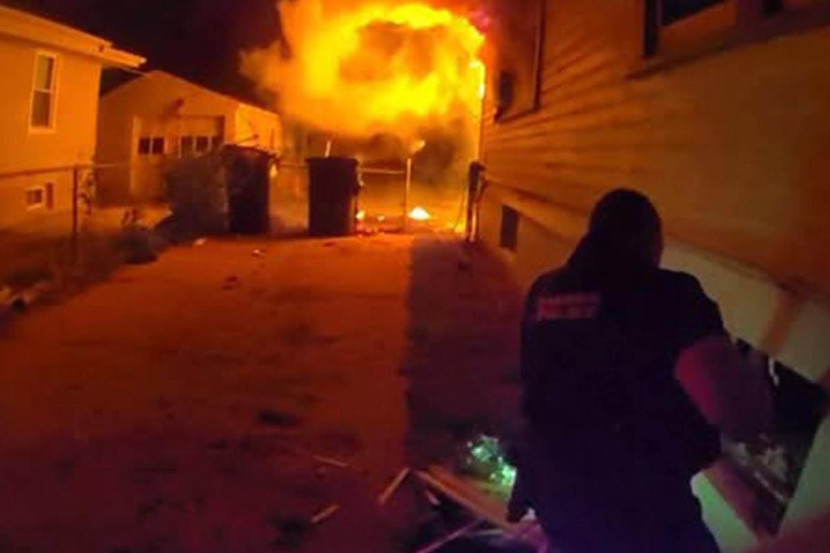 Body camera footage shows Officer David Eckstrom helping a child escape a housefire from a basement window. (Omaha Police Department)