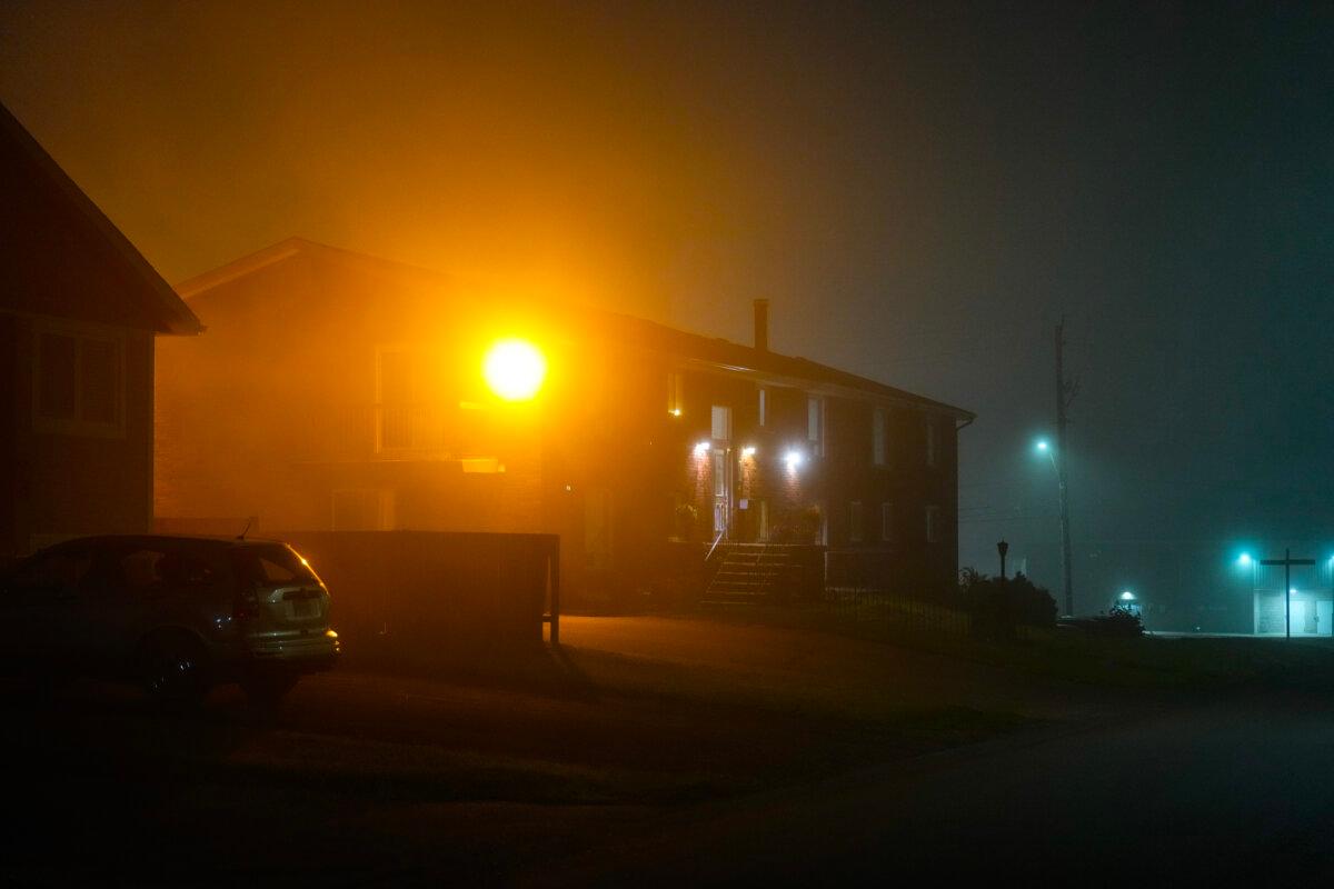 A street stands deserted as smoke from wildfires fills the night air in Thunder Bay, Ont., on July 17, 2026. (The Canadian Press/Chris Young)