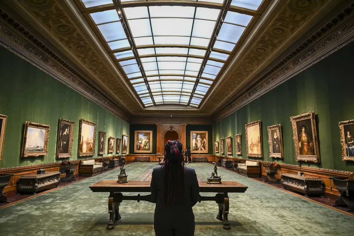 A woman stands in the West Gallery during The Frick Collection press preview in New York City on March 25, 2025. (Angela Weiss/AFP via Getty Images)