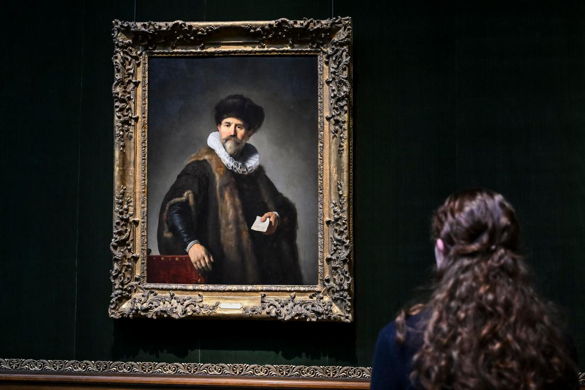 A woman looks at Rembrandt's "Portrait of Nicolaes Ruts" at The Frick Collection press preview in New York City on March 25, 2025. (Angela Weiss/AFP via Getty Images)