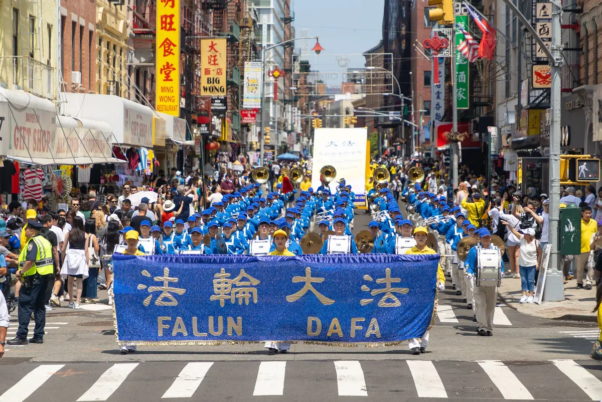 Falun Gong practitioners march during a parade calling for the end of the Chinese Communist Party’s 27 years of ongoing persecution against the spiritual practice, in New York City on July 19, 2026. (Mark Zou/The Epoch Times)