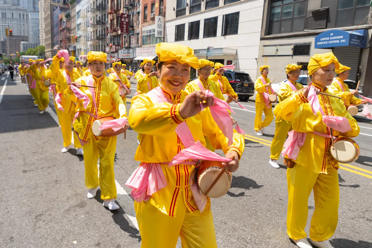 Falun Gong practitioners march during a parade calling for the end of the Chinese Communist Party’s 27 years of ongoing persecution against the spiritual practice, in New York City on July 19, 2026. (Mark Zou/The Epoch Times)