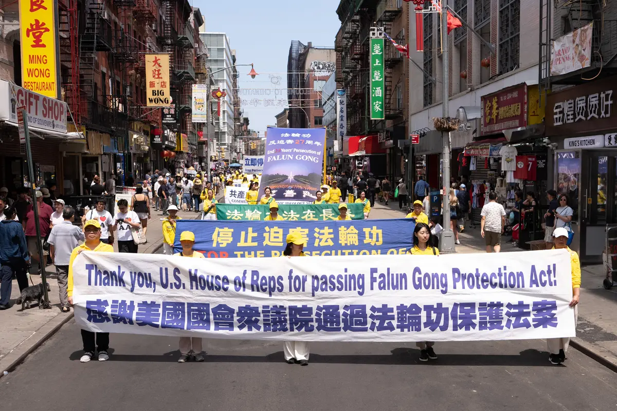 Falun Gong practitioners march during a parade calling for the end of the Chinese Communist Party’s 27 years of ongoing persecution against the spiritual practice, in New York City on July 19, 2026. (Larry Dye/The Epoch Times)