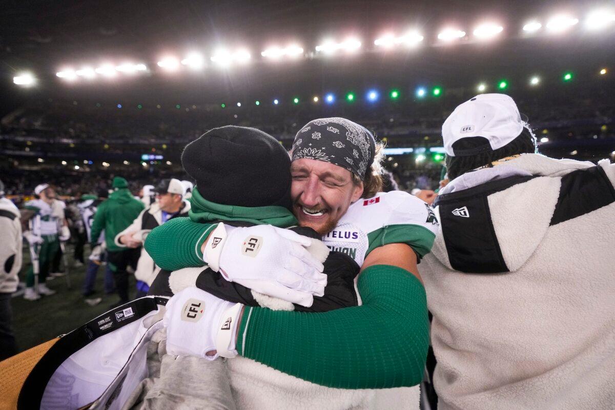 Saskatchewan Roughriders' C.J. Avery (35), left, hugs teammate Jayden Dalke (38) as they celebrate their win over the Montreal Alouettes in the 112th CFL Grey Cup, in Winnipeg on Nov. 16, 2025. (The Canadian Press/Darryl Dyck)