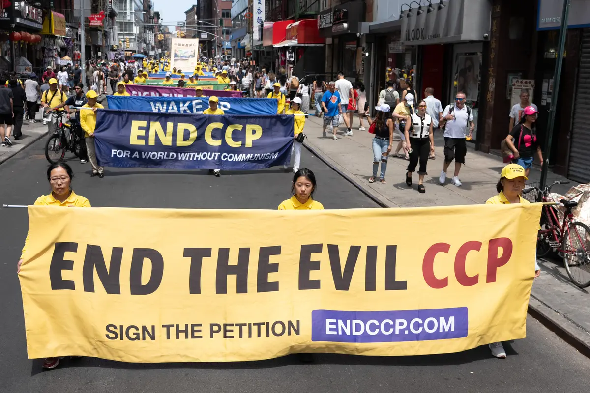 Falun Gong practitioners march during a parade calling for the end of the Chinese Communist Party’s 27 years of ongoing persecution against the spiritual practice, in New York City on July 19, 2026. (Larry Dye/The Epoch Times)