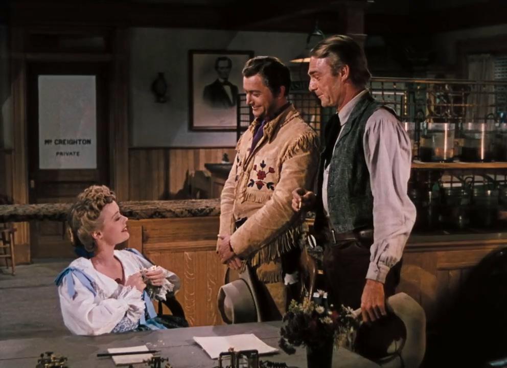 (L–R) Sue Creighton (Virginia Gilmore) entertains suitors Richard Blake (Robert Young) and Vance Shaw (Randolph Scott), in “Western Union.” (20th Century Fox)