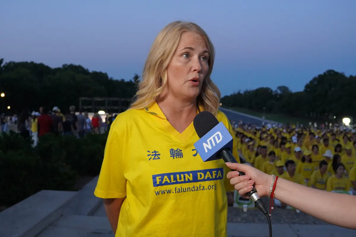 Mary Manthey, a Falun Gong practitioner from Michigan, speaks to reporters during a candlelight vigil at the Lincoln Memorial in Washington on July 23, 2026. (Terri Wu/The Epoch Times)