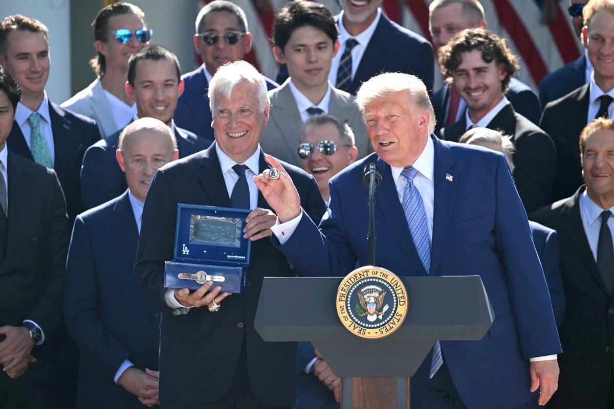 President Donald Trump displays a ring presented to him by Los Angeles Dodgers owner Mark Walter (L) during a ceremony to honor the 2025 World Series champions in the Rose Garden at the White House on July 23, 2026. (Saul Loeb/AFP via Getty Images)