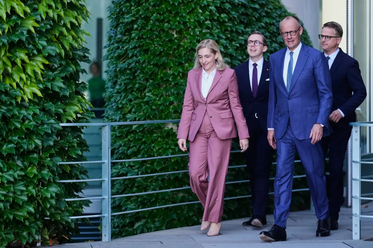 German Chancellor Friedrich Merz, (2R), arrives with Nina Warken, (L), Philipp Amthor, (2L) and Carsten Linnemann, (R), to give a statement about planned personnel changes in his government in Berlin on July 24, 2026. (AP Photo/Markus Schreiber)