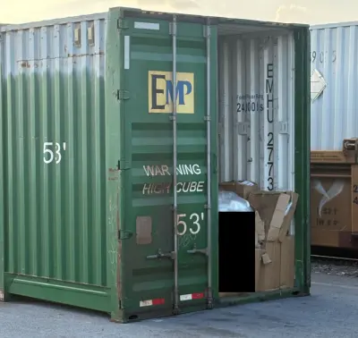 The smuggled migrants were found inside this shipping container at a rail yard in Laredo, Texas, on May 10, 2026. (U.S. DOJ)
