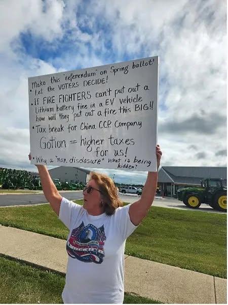 A woman holds a sign to protest the Gotion project near the Gotion facility in Manteno, Ill., in September 2023. (Courtesy of Concerned Citizens of Manteno)