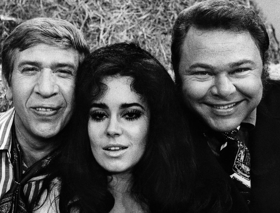 (Left to Right) Buck Owens, Lisa Todd, and Roy Clark from the television program "Hee Haw," 1970. (Public Domain)