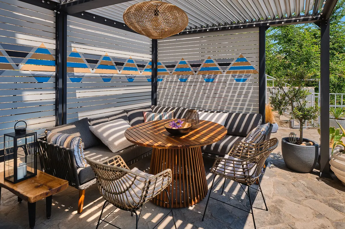 Outdoor curtains and screens can create privacy and extra shade while also helping to block wind. (Vostok/Getty Images)