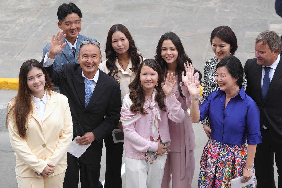 Keiko Fujimori's family waves as they arrive at Congress for her inauguration in Lima, Peru, on July 28, 2026. (Miguel Paredes/AP Photo)