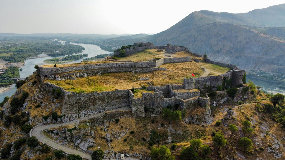 The ruins of Rozafa Castle stand on a hill overlooking the city of Shkoder, Albania. The fortress dates back to antiquity and was expanded by several civilizations throughout its lifetime. (Fabian Kühne/Unsplash)