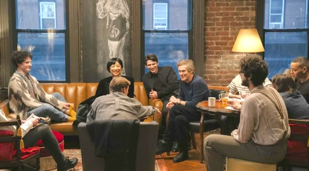 Ed Saxberger (Willem Dafoe, 5th from right) regales young would-be writers with stories of Soho's artist heyday, In "Late Fame." (Magnolia Pictures)