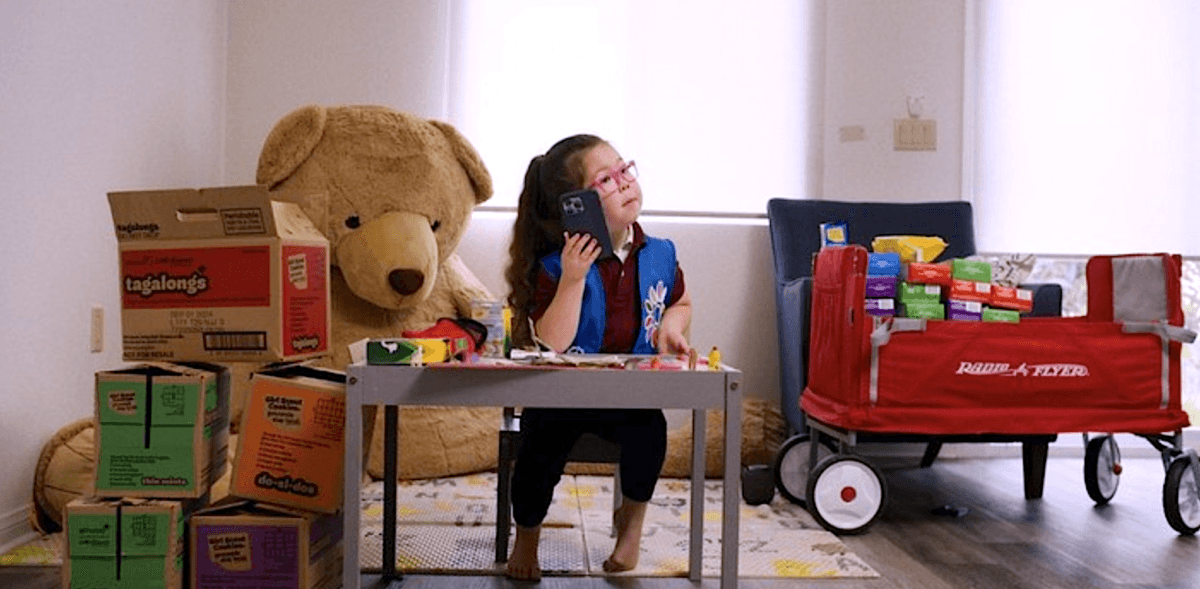 Spunky 5-year-old Ara E. takes a sales call in "Cookie Queens." (Roadside Attractions)