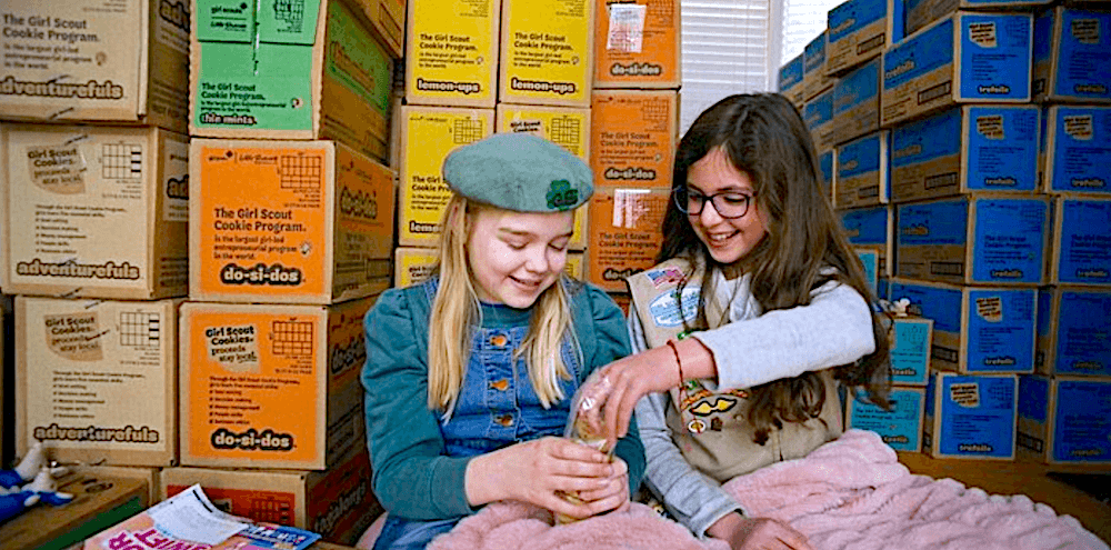 Olive G. (left) and her best friend, fellow Troop 219 member and support buddy Celia K. taste-test the product in "Cookie Queens." (Roadside Attractions)