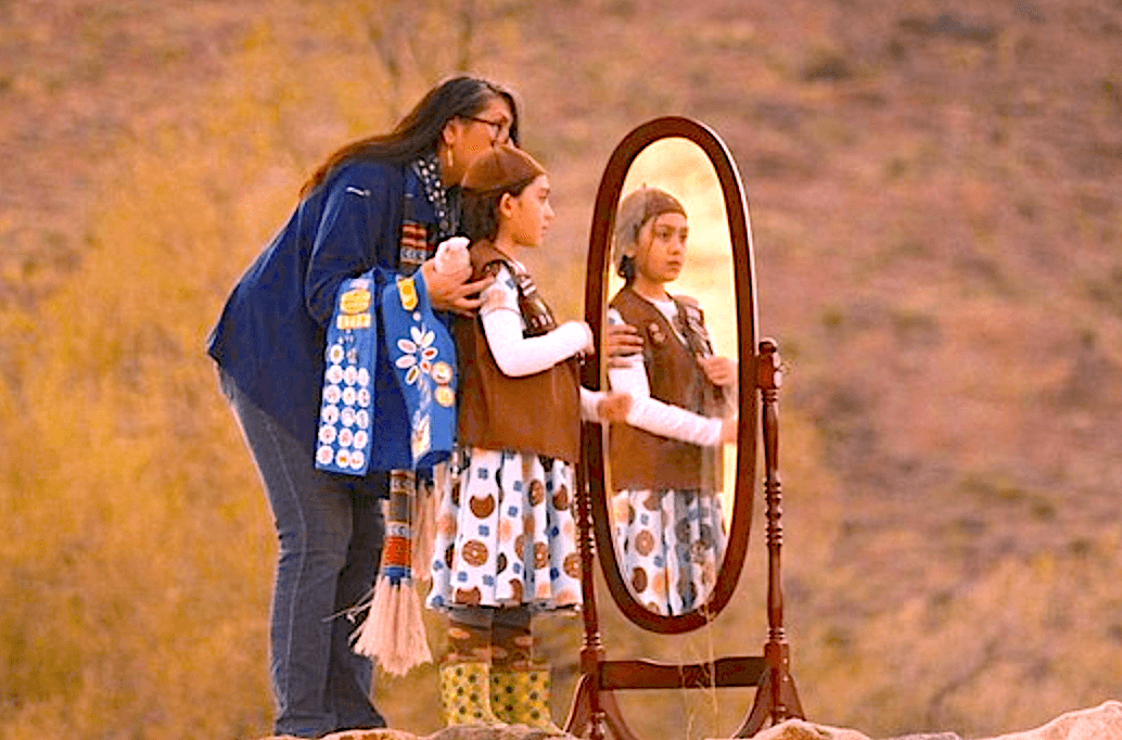 Shannon Elizabeth S. being facilitated by her mother, Amanda, in her Girl Scouts-to-Brownies graduation ritual, in "Cookie Queens." (Roadside Attractions)