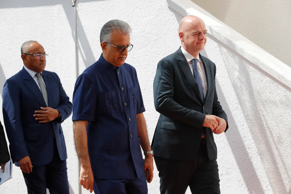 Asia Football Confederation president Salman Bin Ibrahim Al-Khalifa (C) walks with FIFA president Gianni Infantino (R) as they arrive for an inauguration ceremony for the new building of the Asia Football Confederation in Kuala Lumpur, Malaysia on Oct. 30, 2018. (AP Photo/Vincent Thian)