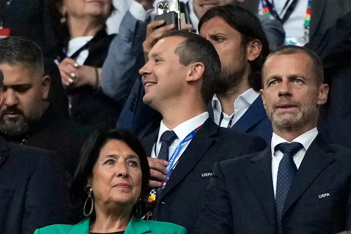UEFA's then-deputy general secretary Kevin Lamour, center, looks on as he stands next to UEFA President Aleksander Ceferin, right, prior to the start of a match between Turkey and Georgia at the Euro 2024 soccer tournament in Dortmund, Germany, on June 18, 2024. (AP Photo/Alessandra Tarantino)