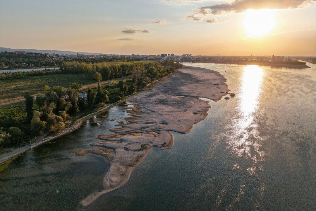 TOPSHOT - This aerial view shows sandbars appearing in the shallow water of the Danube River near Novi Sad, Serbia, on July 27, 2026. Scientists say global warming is increasing droughts and causing weather emergencies to become more extreme and more frequent. Prolonged drought and hot weather across Europe have pushed water levels along the Danube river to record seasonal lows, reaching its lowest flow rate in the last 30 years. (Photo by Nenad MIHAJLOVIC / AFP via Getty Images)