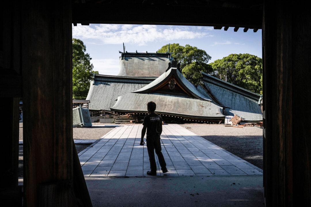 TOPSHOT - A man visits the collapsed Yatsushiro Shrine in Yatsushiro, Kumamoto prefecture on July 29, 2026, after an earthquake struck southwestern Japan the previous day. (Photo by Yuichi YAMAZAKI / AFP via Getty Images)