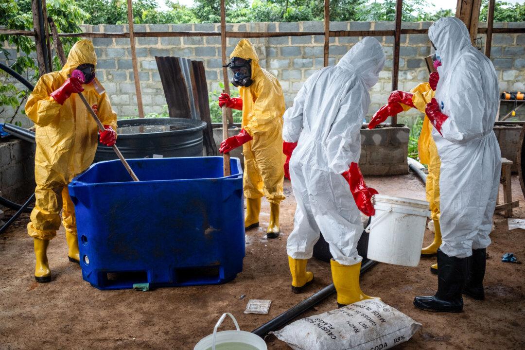 TOPSHOT - Staff from the forensic and chemical monitoring unit of Nigeria's National Drug Law Enforcement Agency (NDLEA) perform a chemical neutralisation process during an operation to dismantle an abandoned clandestine methamphetamine laboratory in Iroto, Ijebu East Local Government Area, Ogun State, on July 29, 2026. The cooking cauldrons and vats of chemicals were left behind in the abandoned shed, hidden in a Nigerian forest - remnants of a multimillion-dollar transnational meth operation.
Nigerian authorities on July 29 dismantled the crude, make-shift meth lab, after an ongoing trial involving three Mexican nationals took a day to hold court proceedings on-site last week. (Photo by TOYIN ADEDOKUN / AFP via Getty Images)
