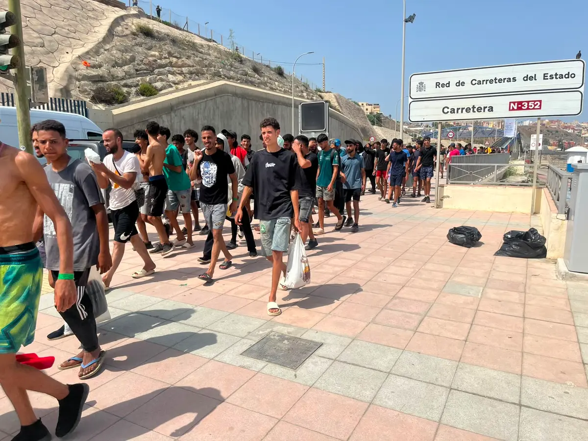 Moroccan illegal immigrants walk along Carretera N-352 near the border in Ceuta, Spain, on Aug. 1, 2026, heading back toward Morocco. (Etienne Fauchaire/The Epoch Times)