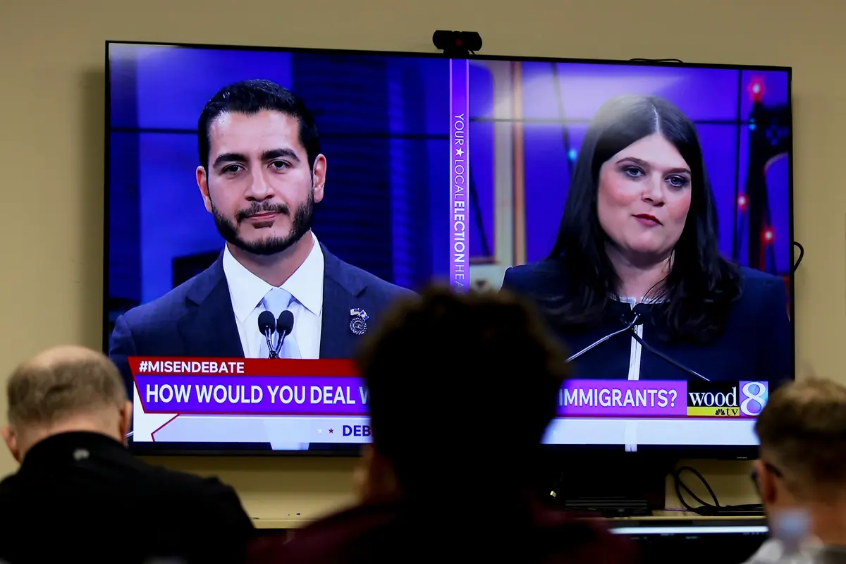 U.S. Senate candidates for Michigan, Abdul El-Sayed (left) and Rep. Haley Stevens (D-Mich.), are seen on television during a debate inside the spin room at WoodTV studios in Grand Rapids, Mich., on July 7, 2026. (AP Photo/Kristen Norman)