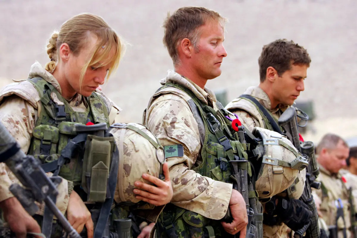 Canadian soldiers attend a Remembrance Day ceremony at the Forward Operating Base Masum Gar in Panjwayi district, Kandahar province, Afghanistan, on Nov. 11, 2006. (John D. McHugh/AFP via Getty Images)