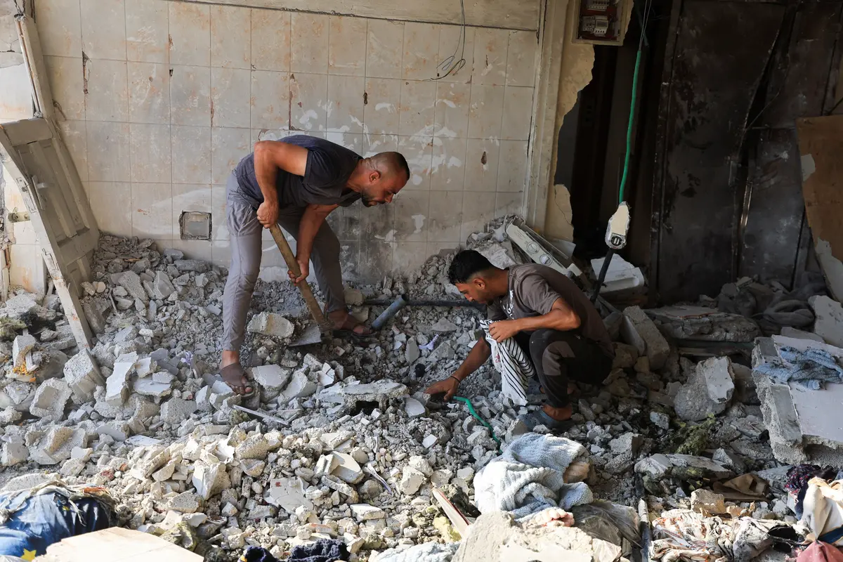 Palestinians inspect the site of an Israeli strike on a residential apartment, according to medics, in Gaza City, Aug. 2, 2026. (Dawoud Abu Alkas/Reuters)